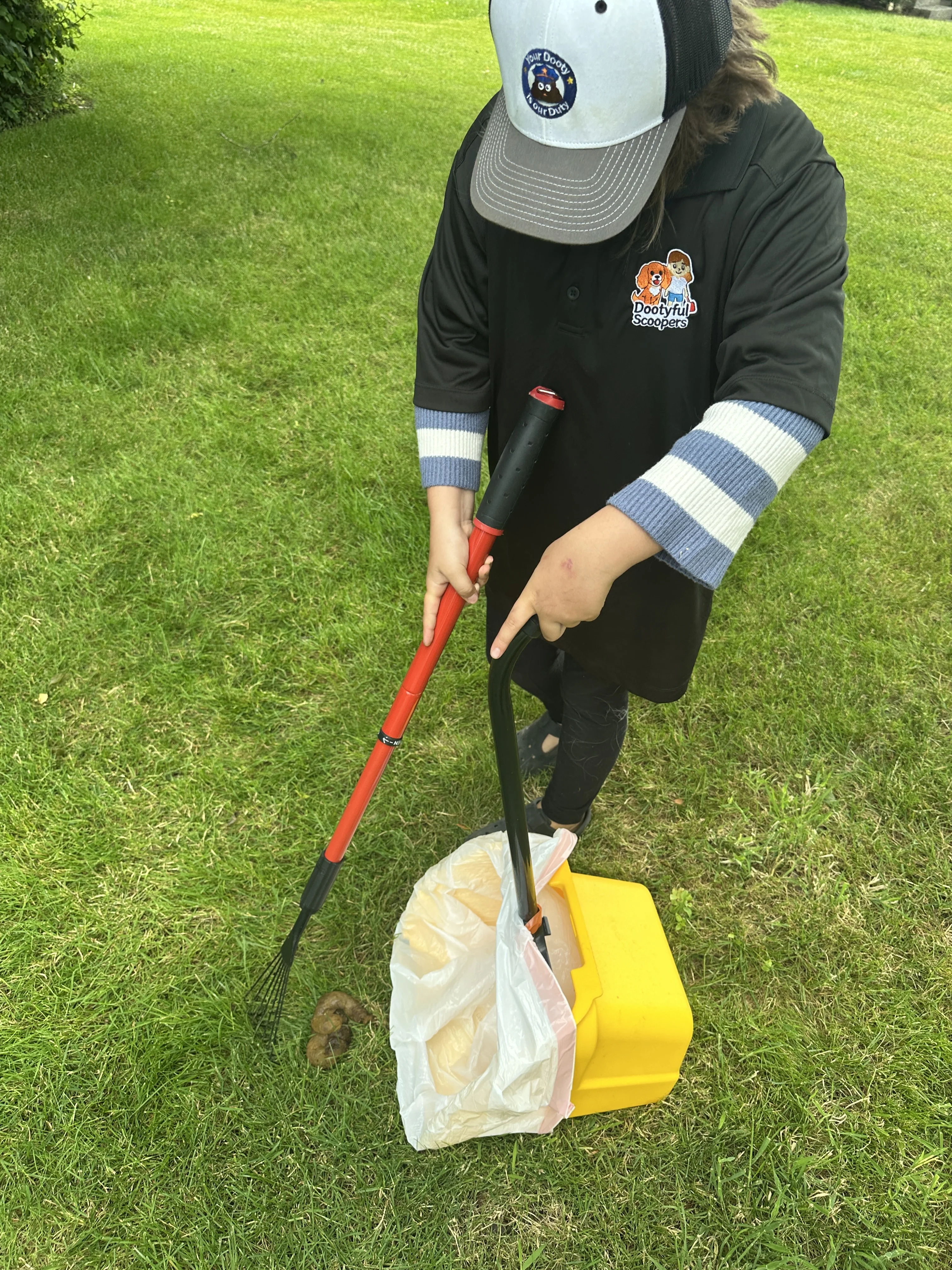 Team member holding the plastic dustbin tray after a cleanup